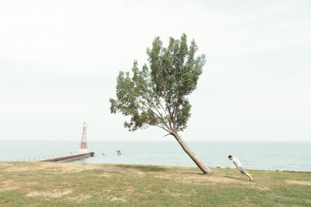 People photographed leaning at impossible angles with trees
