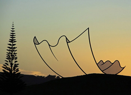 Enormous 2D sheet of paper alighting on a New Zealand hill
