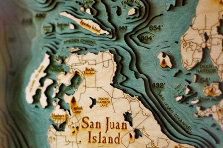 Laser-cut wood maps by Below the Boat