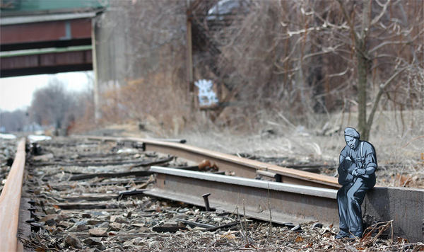 Stunning street art created with little wooden figures