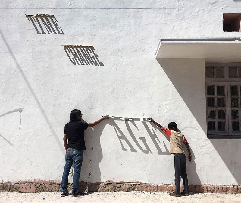 A typographic shadow graffiti that changes during the day